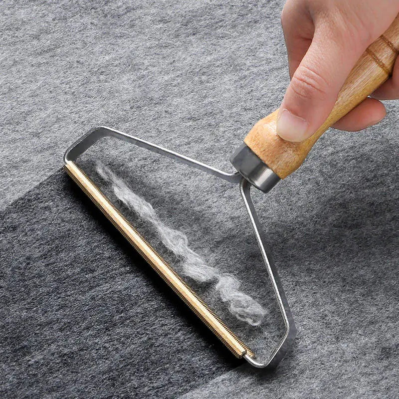Hand using a glass cleaning tool on a smartphone screen against a gray background