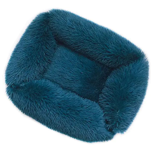 Teal fuzzy pet bed on a white background