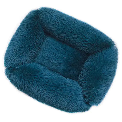 Teal fuzzy pet bed on a white background