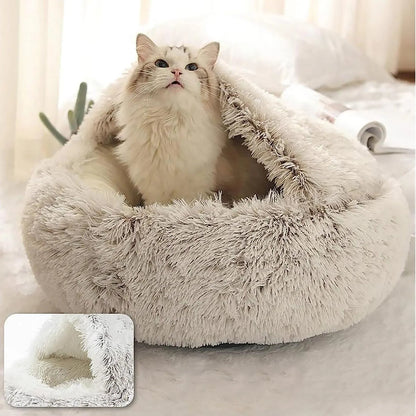 Fluffy white cat bed with a fluffy white cat inside, on a soft surface.