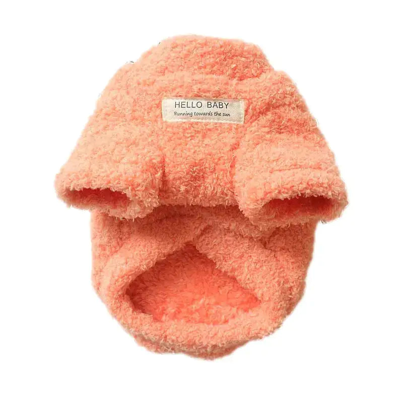 Coral-colored baby bootie with 'Hello Baby' label on a white background