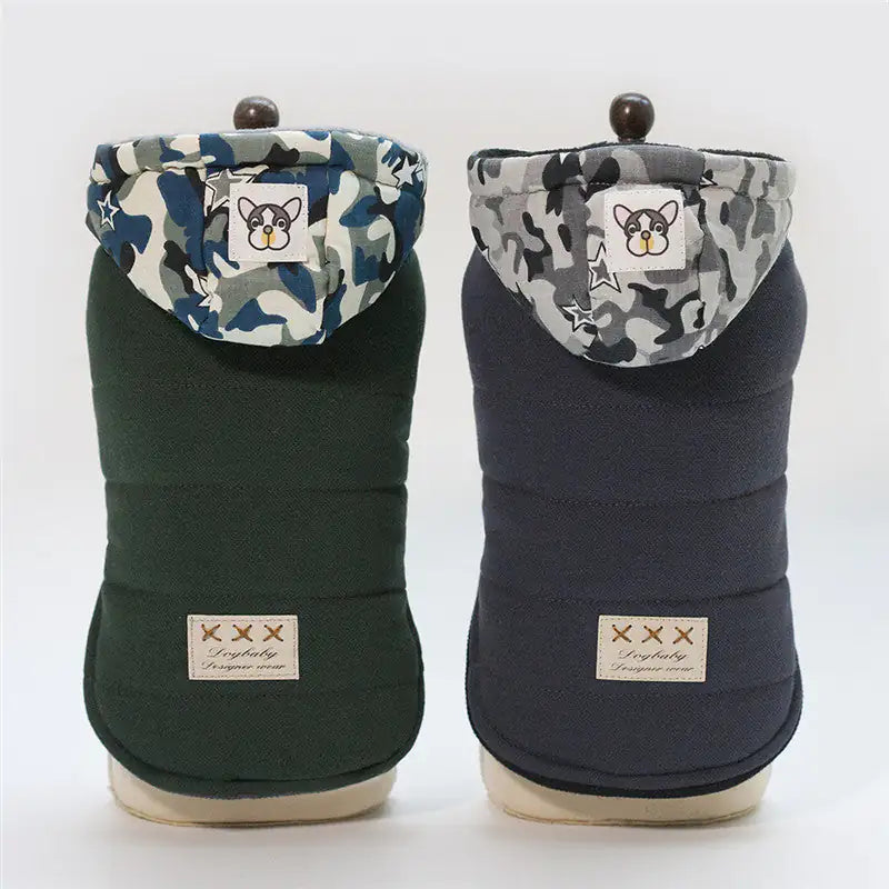 Two dog coats with camouflage patterns on a white background