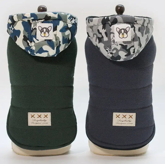 Two dog coats with camouflage hoods and brand labels on a white background