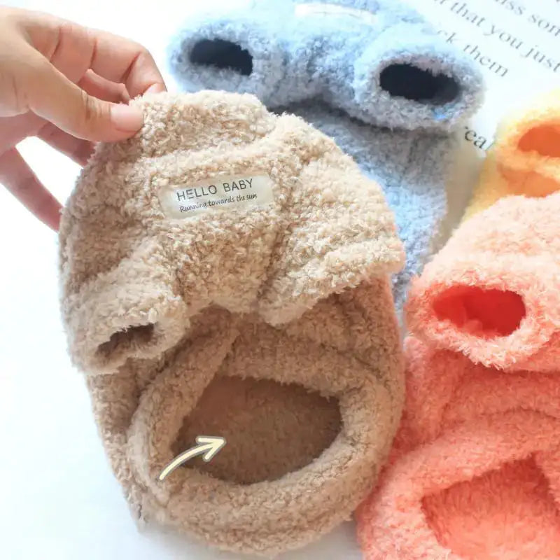 Plush slippers with 'Hello Baby' label on a white background