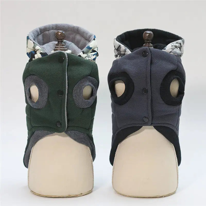 Pair of green and gray pet dog boots on mannequin feet against a white background