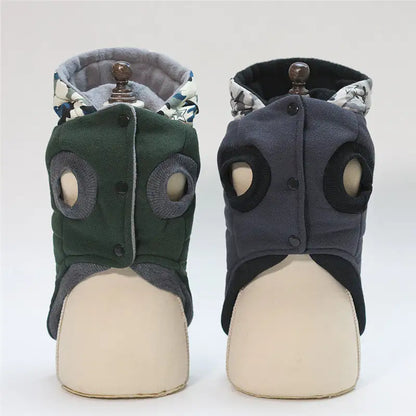 Pair of green and gray pet dog boots on mannequin feet against a white background