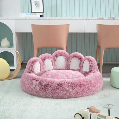 Pink paw-shaped pet bed in a room with chairs and a desk.