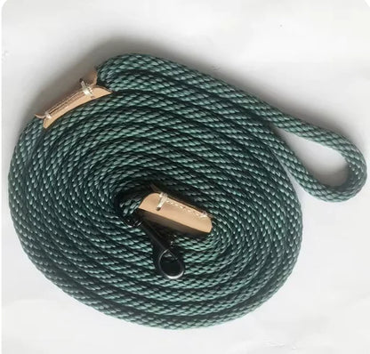 Green rope leash with brass clasp on a white background