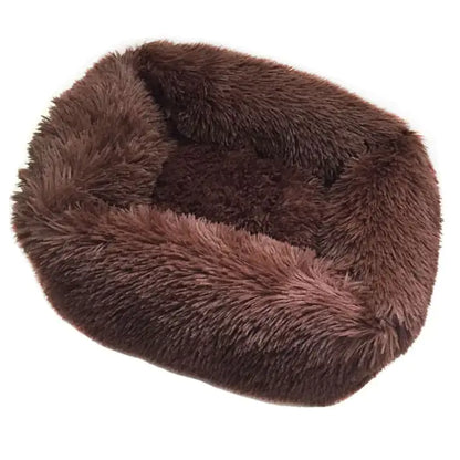 Brown fluffy pet bed on a white background