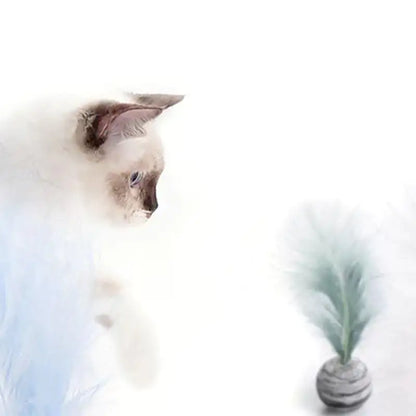 Cat sitting next to a vase with greenery on a white background