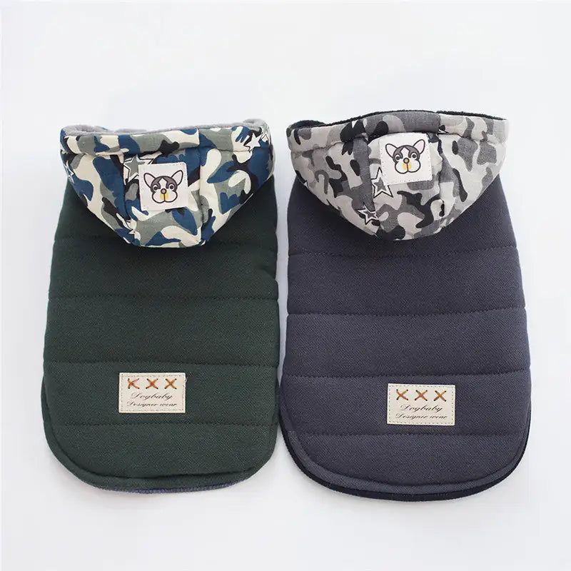 Two dog coats with camouflage hoods on a white background